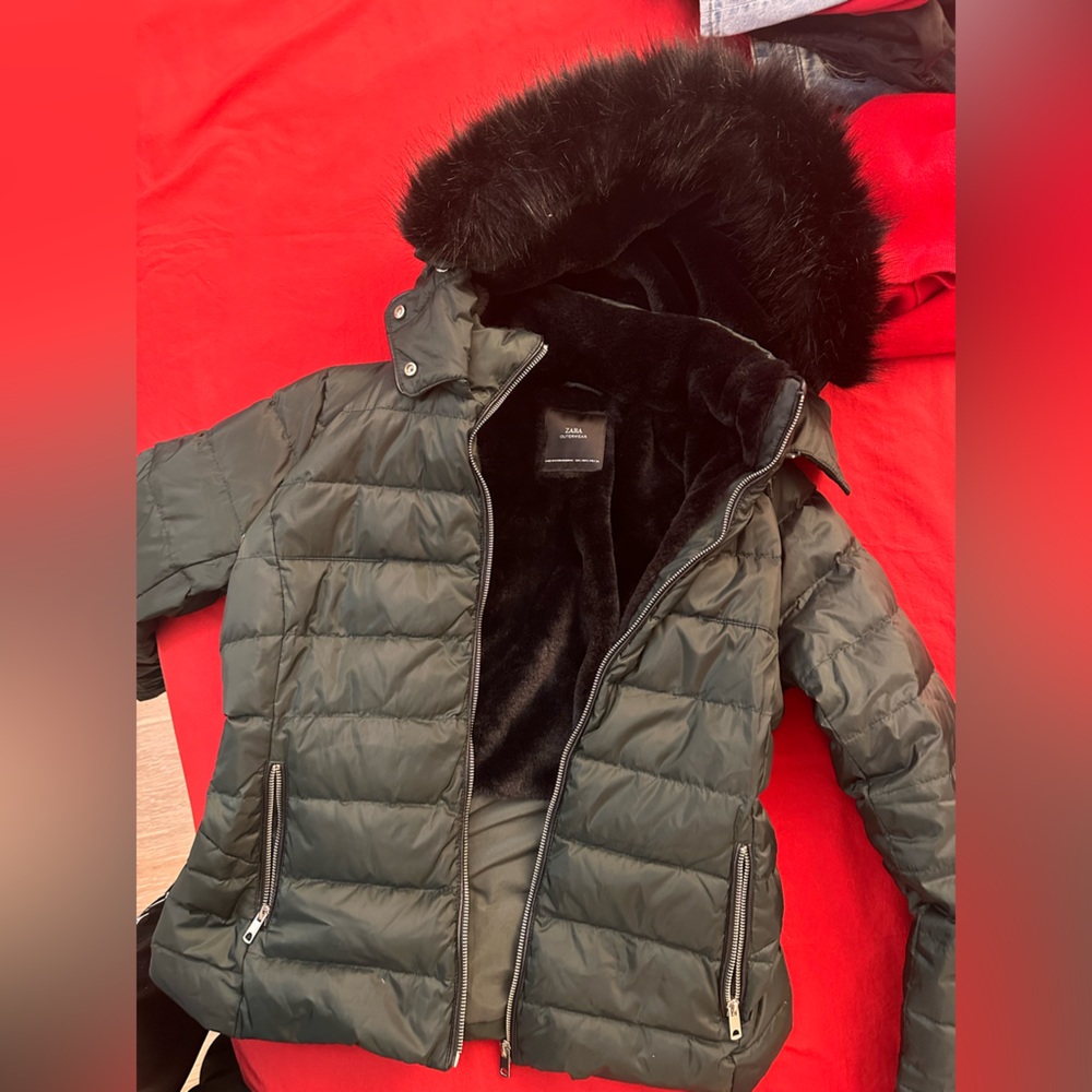 A dark green Zara coat with cosy and beautiful black fur